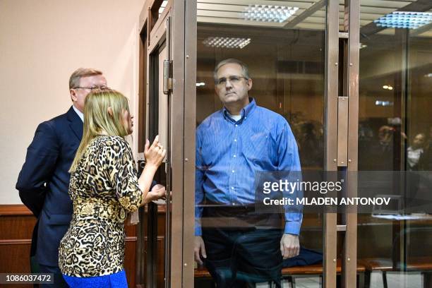 Paul Whelan, a former US Marine accused of espionage and arrested in Russia, listens to his lawyers while standing inside a defendants' cage during a...