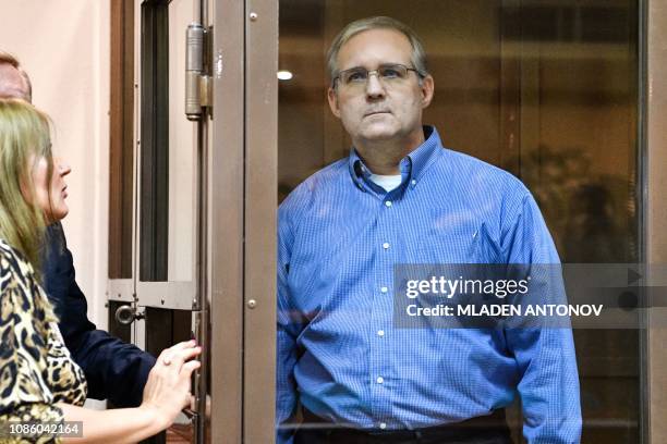 Paul Whelan, a former US Marine accused of espionage and arrested in Russia, listens to his lawyers while standing inside a defendants' cage during a...