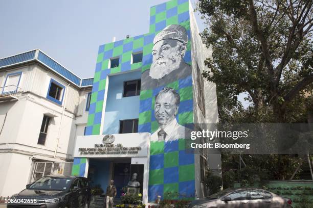 Images of Jamsetji Tata, founder of Tata Group, and Jehangir Ratanji Dadabhoy Tata, former chairman of Tata, are displayed on a building at a Tata...