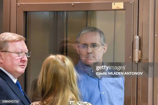 Paul Whelan, a former US Marine accused of espionage and arrested in Russia, stands inside a defendants' cage during a hearing at a court in Moscow...