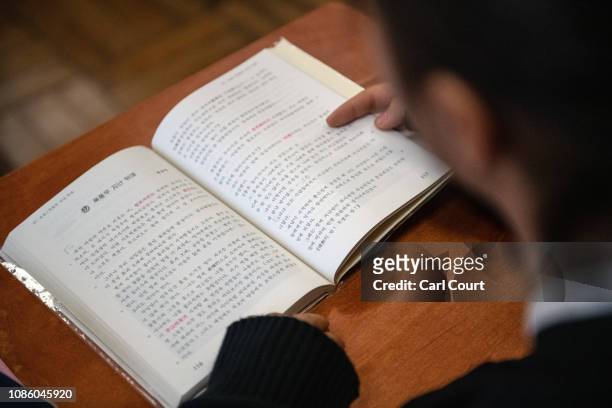 Pupil reads from a Korean-language textbook during a lesson at Tokyo Korean Junior and Senior High School on January 22, 2019 in Tokyo, Japan. The...