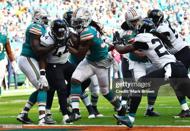 Brandon Bolden of the Miami Dolphins scores a first quarter touchdown against the Jacksonville Jaguars at Hard Rock Stadium on December 23, 2018 in...