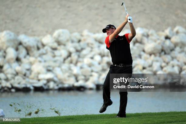 Peter Hanson of Sweden plays his second shot from an awful lie at the 18th hole during the final round of the 2011 Volvo Champions held at the Royal...