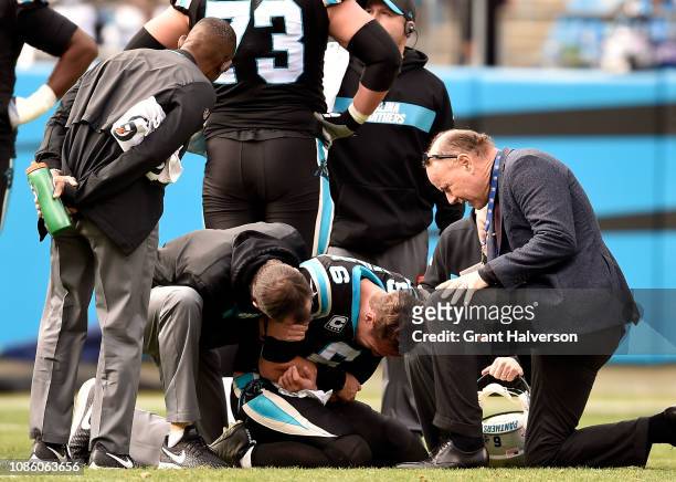 Taylor Heinicke of the Carolina Panthers injures his elbow against the Atlanta Falcons in the second quarter during their game at Bank of America...