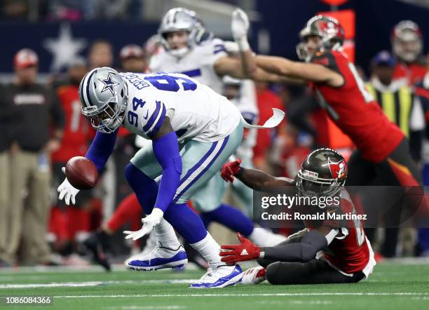 Randy Gregory of the Dallas Cowboys recovers a fumble against Bobo Wilson of the Tampa Bay Buccaneers in the third quarter at AT&T Stadium on...