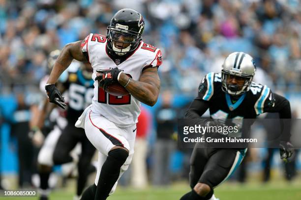 Mohamed Sanu of the Atlanta Falcons runs the ball against Captain Munnerlyn of the Carolina Panthers in the third quarter during their game at Bank...