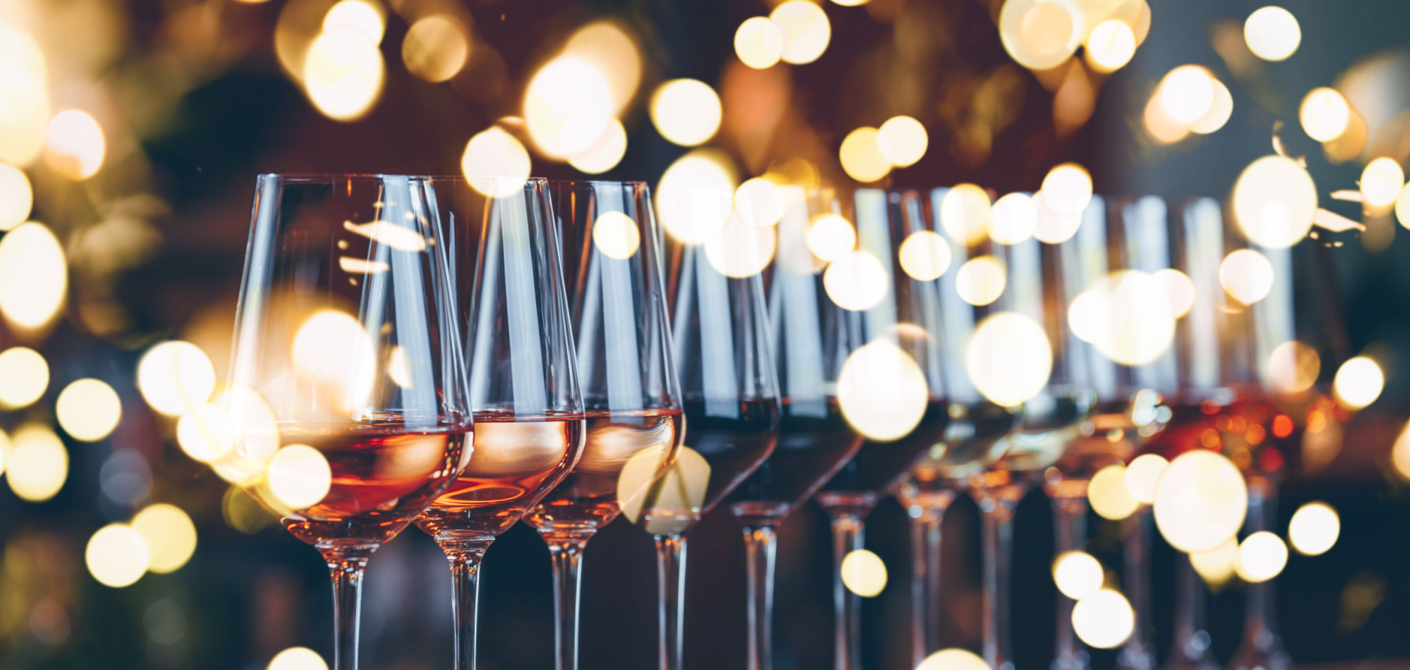 Wine glasses in a row. Buffet table celebration of wine tasting. Nightlife, celebration and entertainment concept Wine glasses in a row. Buffet table celebration of wine tasting. Nightlife, celebration and entertainment concept