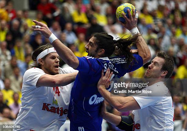 Bertrand Gille of France is challenged by Mikkel Hansen and Kasper Nielsen of Denmark during the Men's Handball World Championship final match...