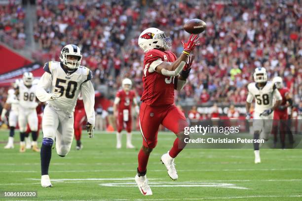 David Johnson of the Arizona Cardinals catches a 32 yard touchdown pass from wide receiver Larry Fitzgerald in the first half of the NFL game against...