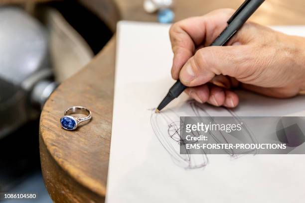 goldsmith designer works on design plans having some jewelry inspirations on paper - jewellery designer stock pictures, royalty-free photos & images