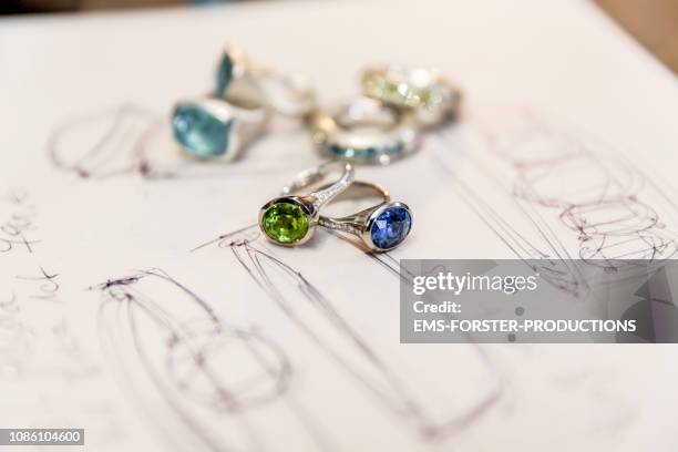 sketches and jewelry on a table - jewellery stock-fotos und bilder