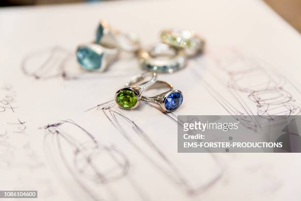sketches and jewelry on a table - precious stones foto e immagini stock