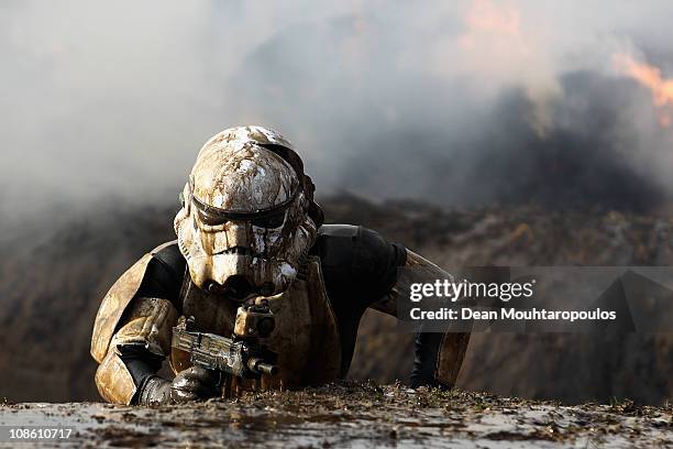 Competitor dressed as a Storm Trooper pushes themselves to the limits as they compete in the 2011 Tough Guy Challenge on January 30, 2011 in Perton,...