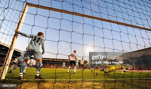 Brede Hangeland of Fulham scores their third goal during the FA Cup sponsored by E.ON 4th Round match between Fulham and Tottenham Hotspur at Craven...