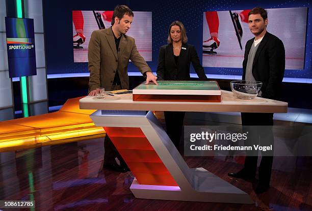 Presenter Claus Lufen, Inka Grings and Daniel Bruehl are seen during the draw for the DFB Cup 2011 Semi Finals during the German Sunday Sports TV...