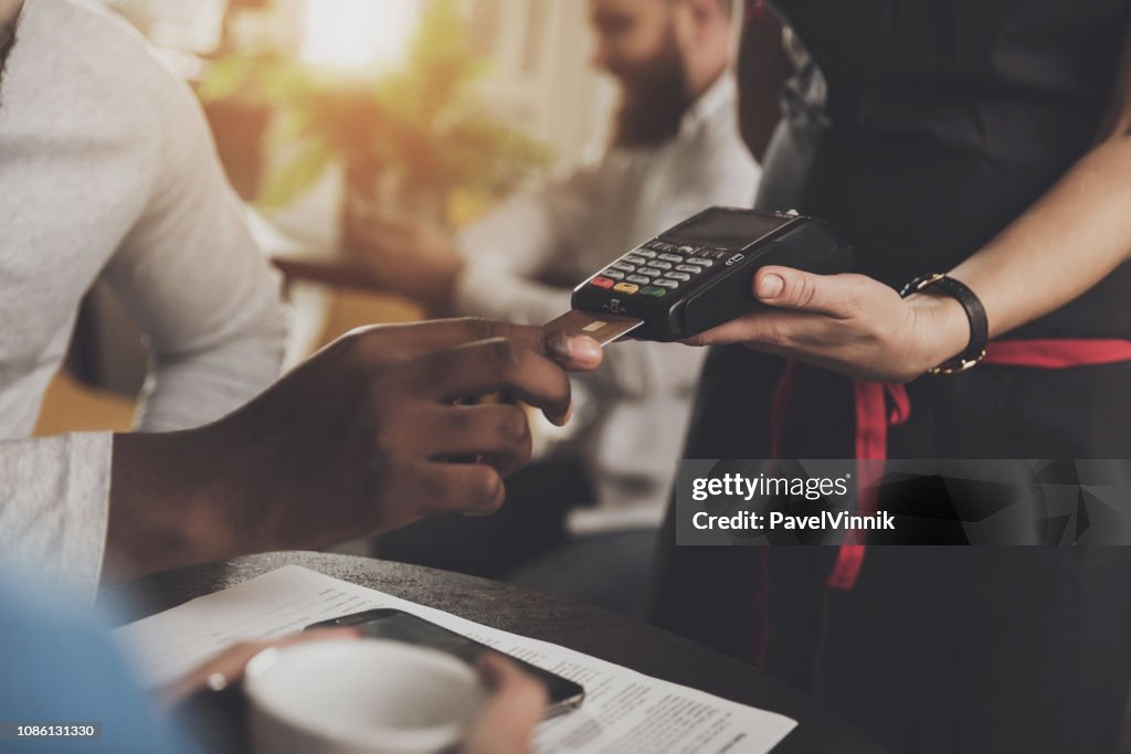 Young African American is calculated credit card