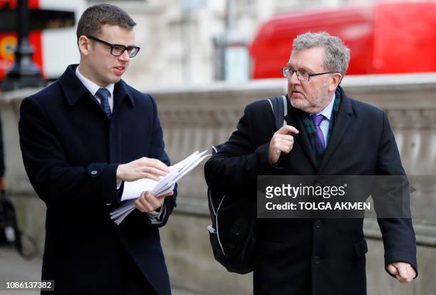 Britain's Scotland Secretary David Mundell walks with an aid carrying paperwork relating to the Government's Brexit Withdrawal Agreement on Whitehall...