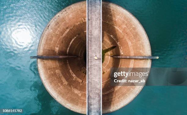 aerial view of man walking on bridge. - hydropower dam stock pictures, royalty-free photos & images