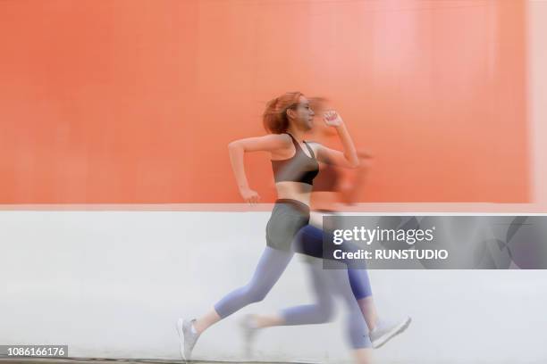 double exposure of woman running - double exposure running stock-fotos und bilder