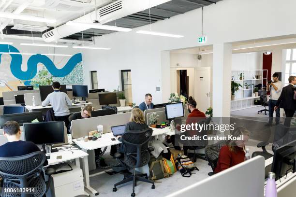 Google employees work in their office during the press tour before the festive opening of the Berlin representation of Google Germany on January 22,...