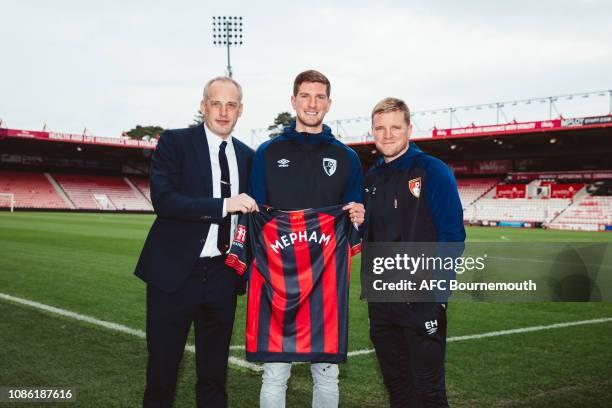 Bournemouth new signing Chris Mepham poses with Chief Executive Neill Blake and manager Eddie Howe at Vitality Stadium on January 22, 2019 in...