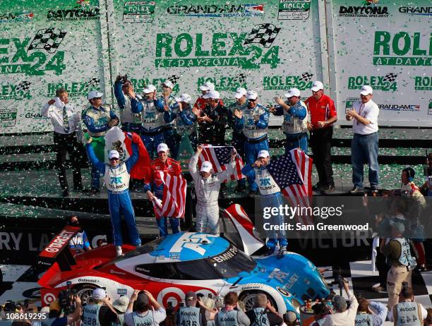 Scott Pruett, Memo Rojas, Graham Rahal. And Joey Hand drivers of the Target/TELEMEX BMW Riley celebrate winning the Rolex 24 at Daytona at Daytona...