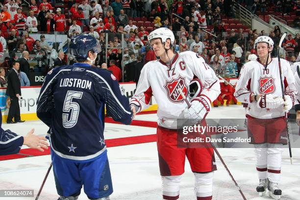 Nicklas Lidstrom of the Detroit Red Wings for team Lidstrom shakes hands with Eric Staal of the Carolina Hurricanes for team Staal after their 11-10...
