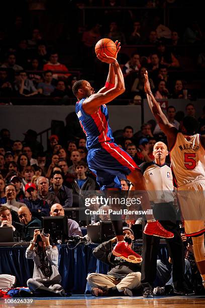 Tracy McGrady of the Detroit Pistons shoots against Bill Walker of the New York Knicks during a game on January 30, 2011 at Madison Square Garden in...