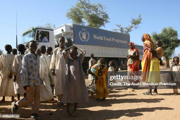 Refugees are seen gathering around a truck of The World Food Programme at a refugee camps are seen on December 9, 2007 in Al Fashir, Darfur, Sudan....