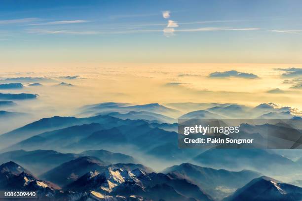 beautiful view on the mountains from the top through the clouds - aerial view cloud ストックフォトと画像