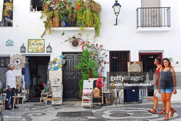 tourists walking and shopping in the old center of frigiliana village - frigiliana stock pictures, royalty-free photos & images