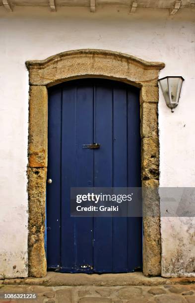 old blue wooden door in a colonial house - parati stock pictures, royalty-free photos & images