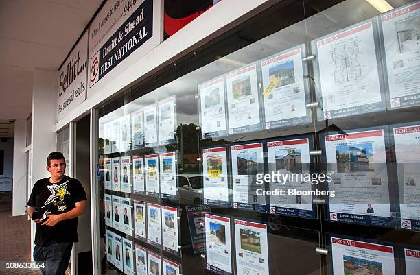 Homes for sale are posted in the window of a real estate agent in Scarborough, a suburb of Perth, Australia, on Monday, Jan. 31, 2011. Property...