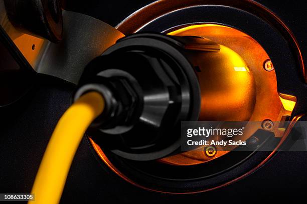 electric auto charging connector glows - hose nozzle stock pictures, royalty-free photos & images