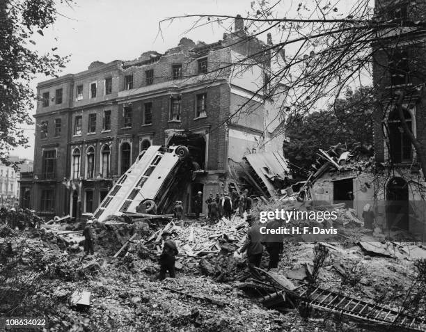 Bus is left leaning against the side of a terrace in Harrington Square, Mornington Crescent, in the aftermath of a German bombing raid on London in...