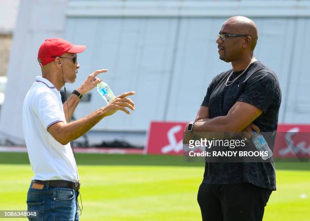Former West Indies players Jimmy Adams and Ian Bishop talk during a training session one day ahead of the 1st Test between England and West Indies at...
