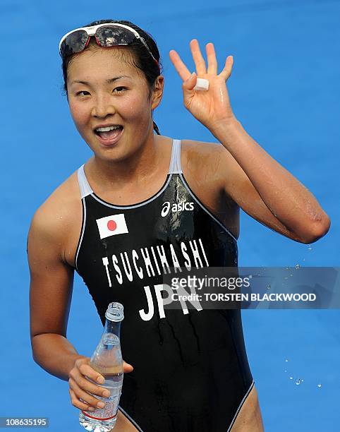 Akane Tsuchihashi of Japan waves after winning silver in the women's triathlon at the 16th Asian Games in Guangzhou on November 13, 2010. Compatriot...