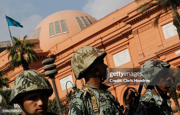 Egyptian Army soldiers stand guard outside of the Museum of Egyptian Antiquities in Tahrir Square on the morning of January 31, 2011 in central...