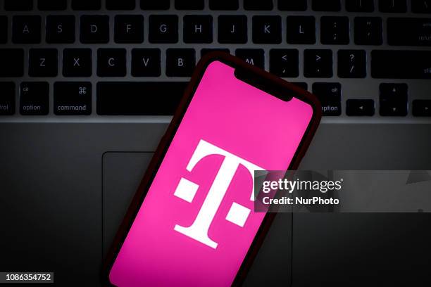 The T-Mobile logo is seen on a portable mobile device in this photo illustration on January 22, 2019.