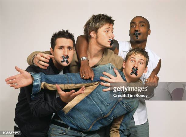 British boy band Blue with their mouths taped shut, London, circa 2003. They are Simon Webbe, Lee Ryan, Duncan James and Antony Costa.