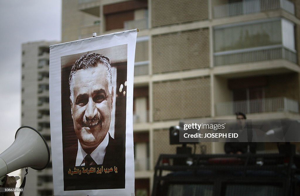 An Egyptian man holds up a poster of for