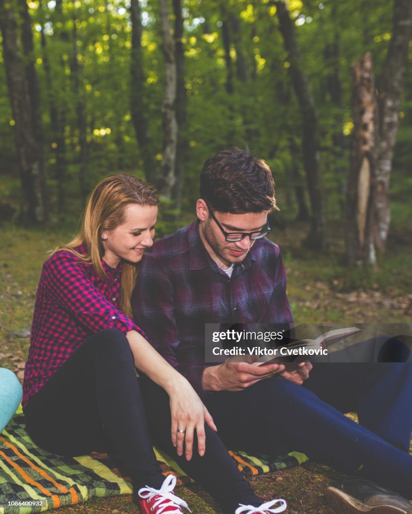 Couple Reading a Book On a Picnic