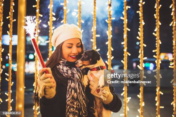 woman and dog - new year's eve - 2018 new years stock pictures, royalty-free photos & images