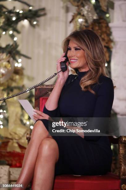 First lady Melania Trump takes phone calls from children as he participates in tracking Santa Claus' movements with the North American Aerospace...