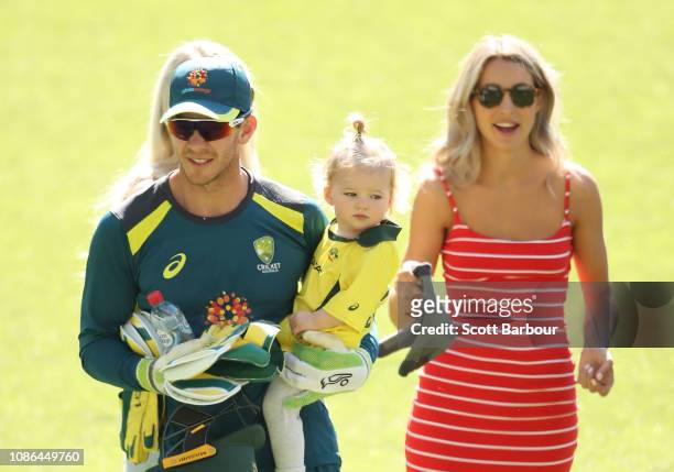 Australian captain Tim Paine holds his daughter Milla as his wife Bonnie Maggs looks on during an Australian training session at Melbourne Cricket...