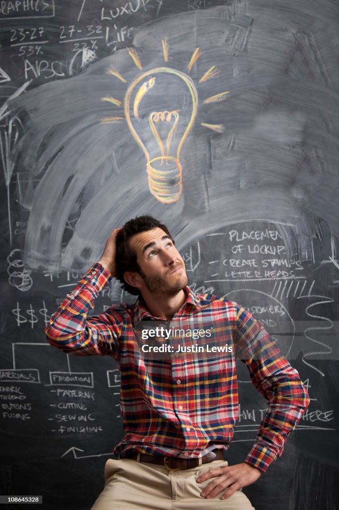 Young man getting an idea with light bulb above