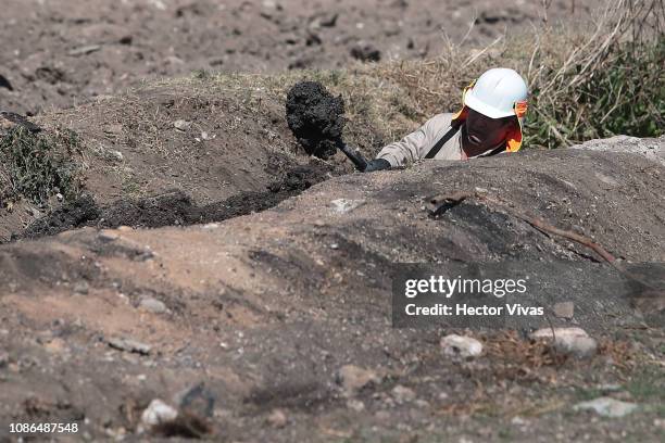 Pemex worker fixes one of the gasoline pipelines after an explosion in a pipeline belonging to Mexican Public Oil Company Pemex on January 22, 2019...