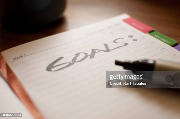 a single word "goal" written on a small note pad - starting a new business stock pictures, royalty-free photos & images