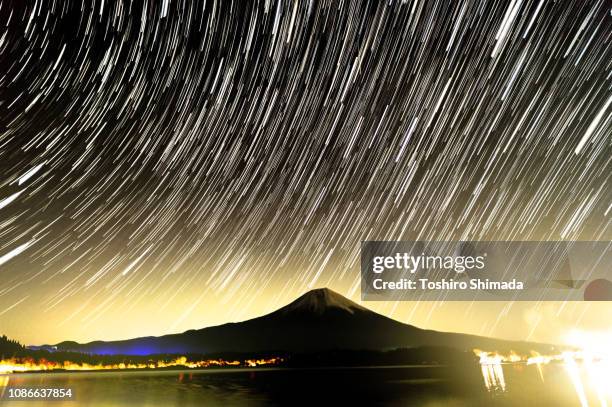 star trail and geminid meteor shower and mt.fuji - meteor shower stock-fotos und bilder