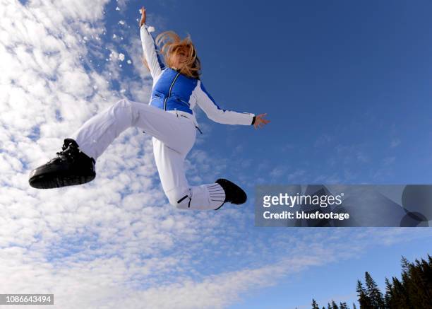 joyful jump through the air - スキーパンツ ストックフォトと画像